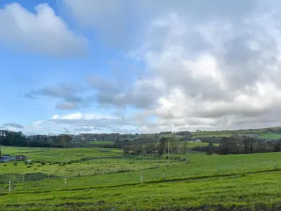 a field of green grass with a cloudy sky at Harebeck Cottage in Gosforth