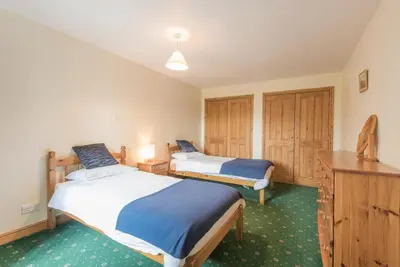 a bedroom with two beds and a desk and cabinets at 2 Bed in Threlkeld SZ134 in Threlkeld