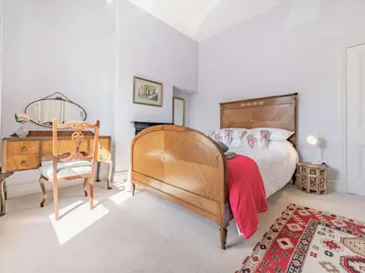 a bedroom with a bed and a desk and a chair at 2 bed in Keswick 87732 in Keswick