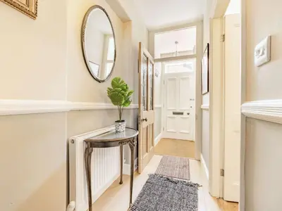 a hallway with a table and a mirror at 2 bed in Keswick 87732 in Keswick