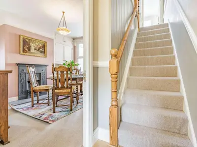 a staircase in a living room with a table and chairs at 2 bed in Keswick 87732 in Keswick