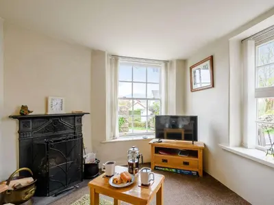 a living room with a fireplace and a tv at 1 Bed in Eskdale SZ503 in Beckfoot