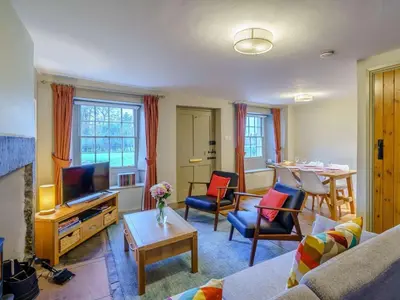 a living room with a couch and a tv and a table at 2 Bed in High Lorton 86023 in Lorton