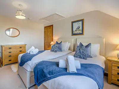 a bedroom with two beds with blue and white sheets at 5 Bed in Cleator oc-sz529 in Ennerdale Bridge
