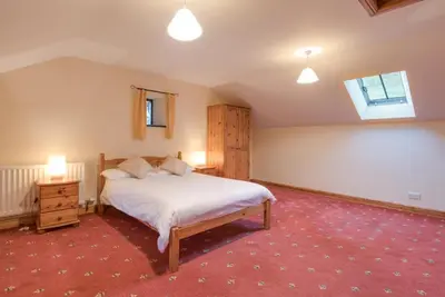 a bedroom with a large bed and a window at 3 Bed in Threlkeld SZ433 in Threlkeld