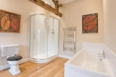 a bathroom with a shower and a toilet and a tub at 2 Bed in Boltongate SZ396 in Mealsgate