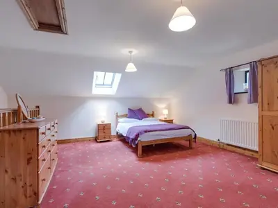 a bedroom with a bed and a red carpet at 3 Bed in Threlkeld SZ083 in Threlkeld