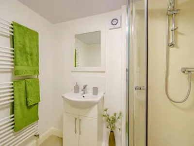 a white bathroom with a sink and a shower at 2 Bed in Cockermouth 85514 in Cockermouth
