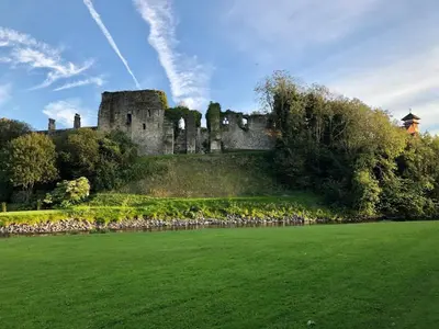 a castle on a hill with a flock of sheep at 2 Bed in Cockermouth 85514 in Cockermouth