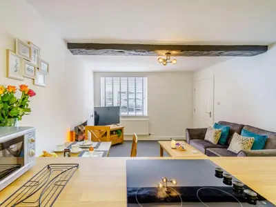 a living room with a couch and a table at 2 Bed in Cockermouth 85514 in Cockermouth