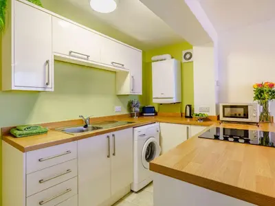 a kitchen with white cabinets and a sink at 2 Bed in Cockermouth 85514 in Cockermouth