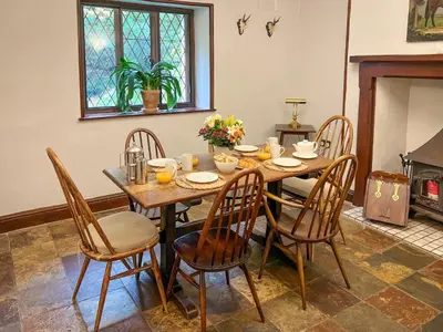 a dining room with a table and chairs at Daweswood, Patterdale, characterful with fairy tale garden and fell walks from the door in Patterdale