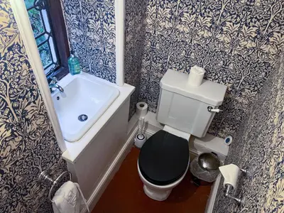 a small bathroom with a toilet and a sink at Daweswood, Patterdale, characterful with fairy tale garden and fell walks from the door in Patterdale
