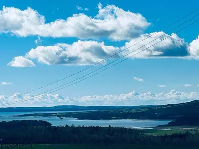 a view of a body of water and clouds at High Tide Lodge in Gatehouse of Fleet