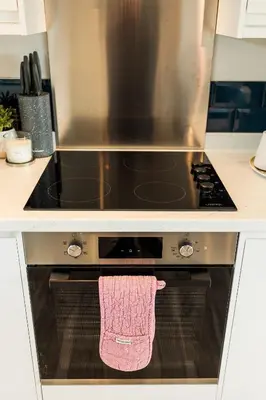 a towel hanging on the oven door of a stove at High Tide Lodge in Gatehouse of Fleet