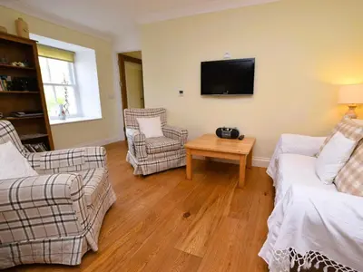 a living room with two couches and a tv at 4 Bed in Moffat 82374 in Moffat