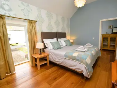 a bedroom with a bed and a large window at 4 Bed in Moffat 82374 in Moffat