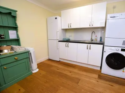 a kitchen with white appliances and a green cabinet at 4 Bed in Moffat 82374 in Moffat