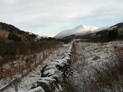 a stone fence in a field with snow on it at 4 Bed in Moffat 82374 in Moffat