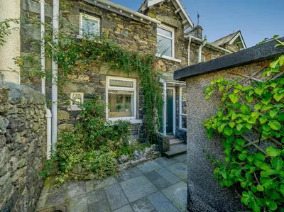 a stone house with ivy on the side of it at 2 Bed in Glenridding 85425 in Glenridding
