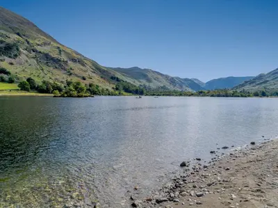 a body of water with mountains in the background at 2 Bed in Glenridding 85425 in Glenridding