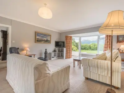 a living room with white furniture and a large window at 3 Bed in Portinscale SZ528 in Portinscale
