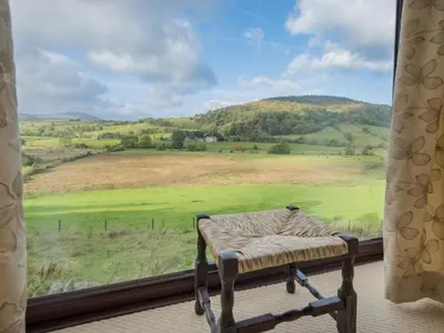 a window with a bed and a view of a field at 1 Bed in Matterdale SZ222 in Watermillock