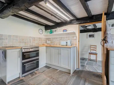 a kitchen with white cabinets and a stove at 3 Bed in Seathwaite SZ107 in Eskdale