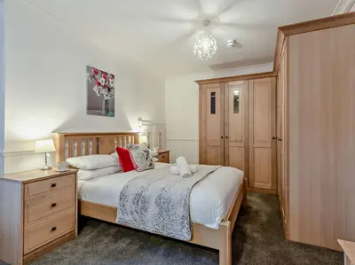 a bedroom with a bed and a dresser and a bed sidx sidx sidx sidx at 2 Bed in Rosthwaite 86397 in Rosthwaite