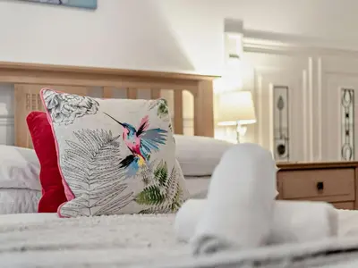 a pillow with a bird on it sitting on a bed at 2 Bed in Rosthwaite 86397 in Rosthwaite