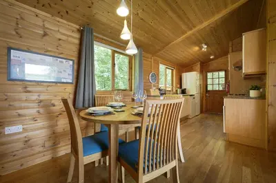 a kitchen and dining room with a table and chairs at Egret Lodge with Hot-tub in Carlisle