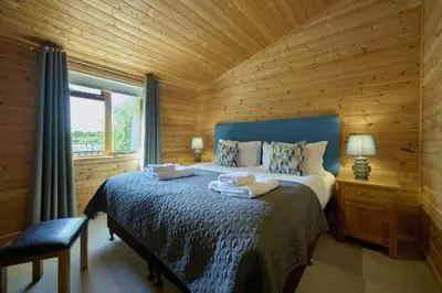 a bedroom with a bed with two towels on it at Egret Lodge with Hot-tub in Carlisle