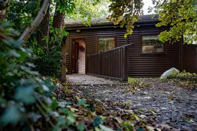 a log cabin with a porch and a door at Heron Lodge with Hot-tub in Carlisle