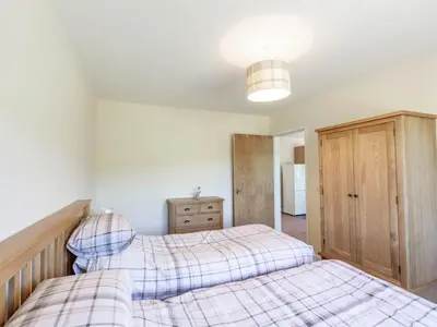 a bedroom with two twin beds and a cabinet at 3 Bed in Moffat oc-ca402 in Moffat