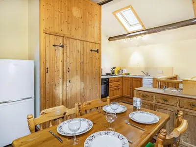 a kitchen with a table and chairs and a refrigerator at 2 Bed in Wasdale Head SZ053 in Nether Wasdale