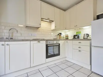 a white kitchen with white cabinets and appliances at 2 Bed in Keswick oc-sz009 in Keswick
