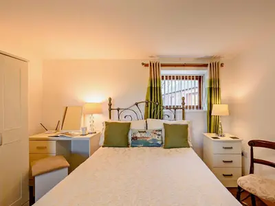 a bedroom with a bed and a desk and a window at 1 Bed in Allonby 28791 in Allonby