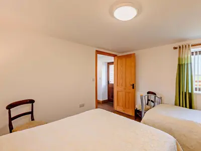 a small bedroom with two beds and a window at 1 Bed in Allonby 28791 in Allonby