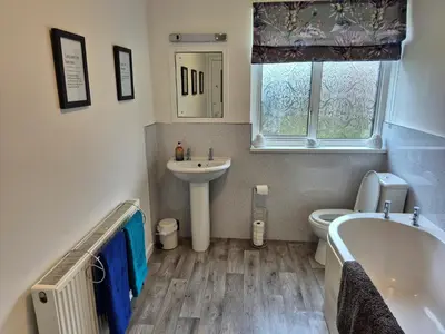 a bathroom with a tub and a toilet and a sink at 3 Bed in Auldgirth 77430 in Auldgirth