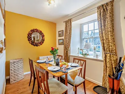 a dining room with a table and chairs and a window at 2 Bed in Keswick 80515 in Keswick