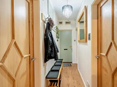 a hallway with a bench and a coat rack at 2 Bed in Keswick 80515 in Keswick