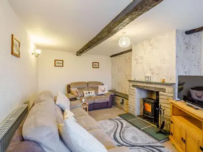 a living room with a couch and a fireplace at 3 Bed in Threlkeld 86613 in Threlkeld