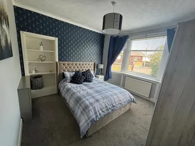 a small bedroom with a bed and a window at Tigh Lochlainn in Prestwick