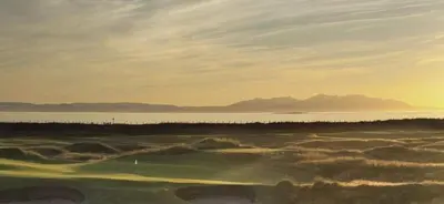 a view of a golf course with the ocean in the background at Tigh Lochlainn in Prestwick