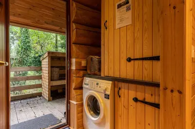 a washer and dryer in a log cabin at Alder Lodge with Hot-tub in Carlisle