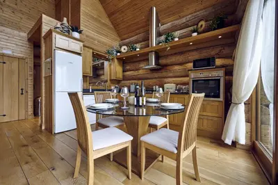 a kitchen and dining room with a table and chairs at Alder Lodge with Hot-tub in Carlisle