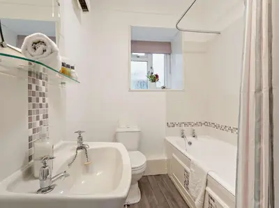 a white bathroom with a sink and a toilet at 1 Bed in Rosthwaite 86395 in Rosthwaite