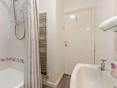 a bathroom with a tub and a sink and a shower at 1 Bed in Rosthwaite 86395 in Rosthwaite