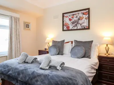a bedroom with a bed with towels on it at Rainbow End in Ambleside
