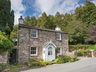 an old stone house with a white door at 3 Bed in Eskdale SZ416 in Santon Bridge